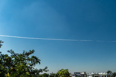 Jan.6th2025. Dehradun City Uttarakhand India. Contrails, or condensation trails, form white lines behind jets in the skies above Uttarakhand, India. A striking sight of aviation in action.の写真素材