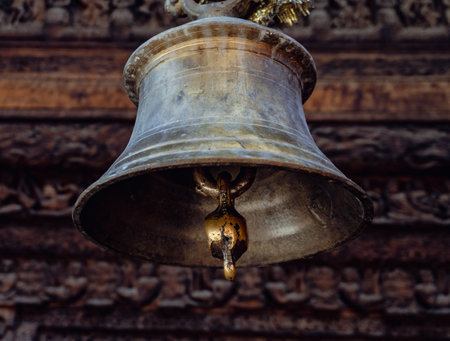 July25th2024, Himachal Pradesh, India. Old bells against century-old carved wooden sculpture at Chaurasi Temple in Bharmour, Chamba, Himachal Pradesh, part of the Manimahesh Kailash pilgrimage.の写真素材