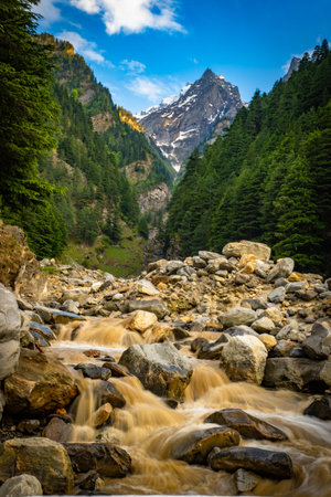 Twin peaks in Harsil Valley, Uttarkashi, with a glacial river flowing to Bhagirathi, a main Ganga...