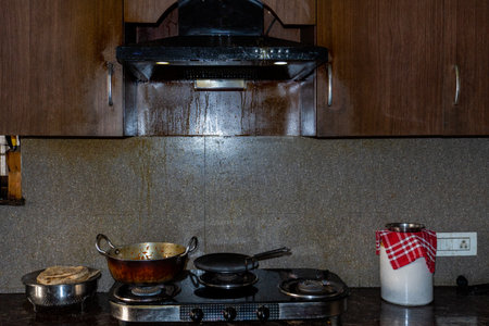A heavily greased Indian kitchen chimney with oil stains covering the exhaust, showcasing real kitchen wear.の写真素材
