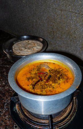 Traditional Indian Arhar Dal Tadka preparation with rich spices, cooked in a home kitchen for authentic flavorsの写真素材