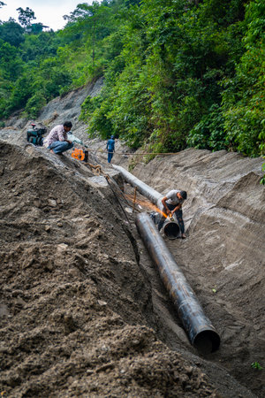 September20th2025 Dehradun Uttarakhand, India. Pipeline repair and welding underway in Rajpur village after cloudburst floods in Rispana River, Uttarakhandの写真素材