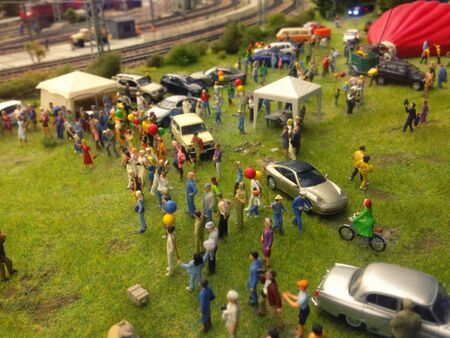 Picnic with cars and people in the toy city.の写真素材