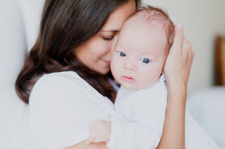 Portrait of a newborn in the arms of the motherの写真素材