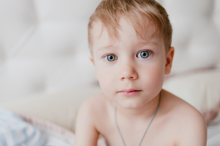 Home portrait of a little boy looking at the cameraの写真素材