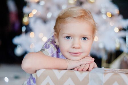 Christmas portrait of a little girl near Christmas tree
