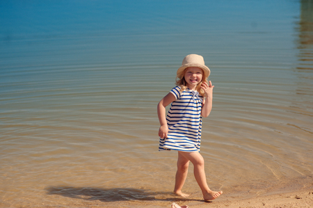 girl playing in water on beach and laughingの写真素材