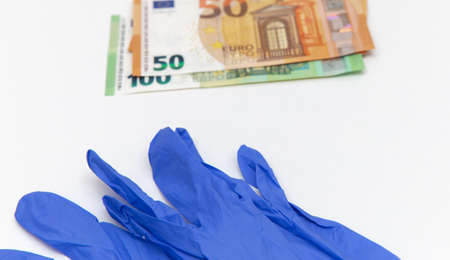 Blue latex gloves and 50 and 100 euro bills. For the cashier or seller, sale of latex glovesの写真素材