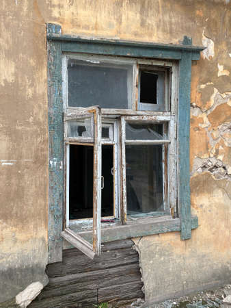 Broken window of an old house. The house is ready for demolition, destruction.の写真素材