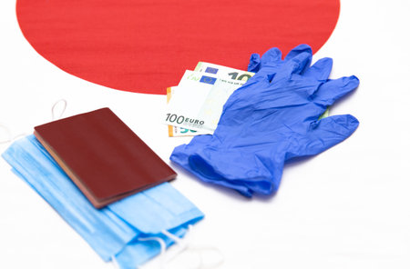 Blue gloves, masks and euro banknotes are on the national Japanese flag. Document. Competitions in Japan, tourism.の写真素材