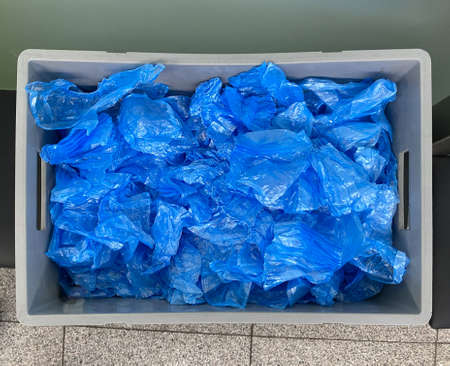 Blue shoe covers. Plastic polyethylene material in a plastic box. For visitors, customers and patientsの写真素材