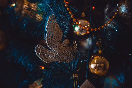 Christmas tree, beautiful magic toys, golden pigeon, magic garlands on the branches of the tree. Selective focusの写真素材