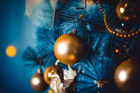 Turquoise, blue, gold image of Christmas toy and tree. A magical picture. Mystery and comfort. For a calendar or postcard. Selective focusの写真素材