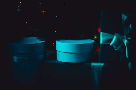 Turquoise gifts in a dark room, low key. A magical picture. Mystery and comfort. For a calendar or postcardの写真素材