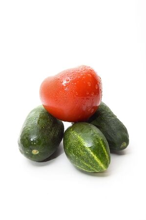 Cucumbers and tomato on white backgroundの写真素材