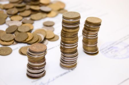 Different coins on contract backgroundの写真素材
