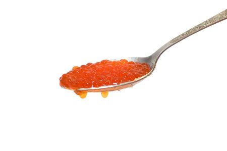 Red caviar at spoon on white backgroundの写真素材