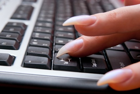 Female working on personal computer. Close up.