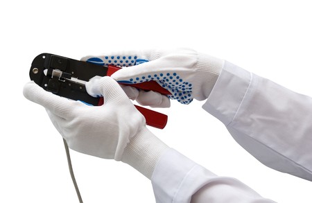 hand with gloves keeps wire cable crimperの写真素材