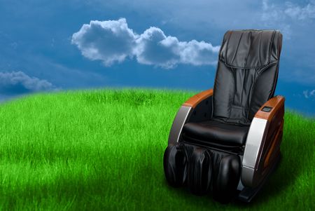 massage arm-chair on the green grass field.  の写真素材