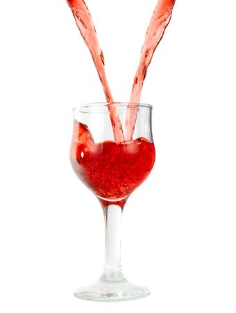 pouring red wine in goblets isolated on whiteの写真素材