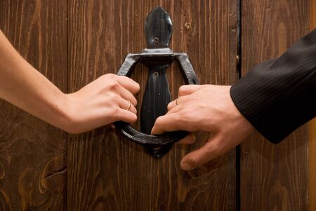 Close up of just married hands opening the door togetherの写真素材