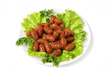 grilled sausages on green lettuce with isolated on whiteの写真素材