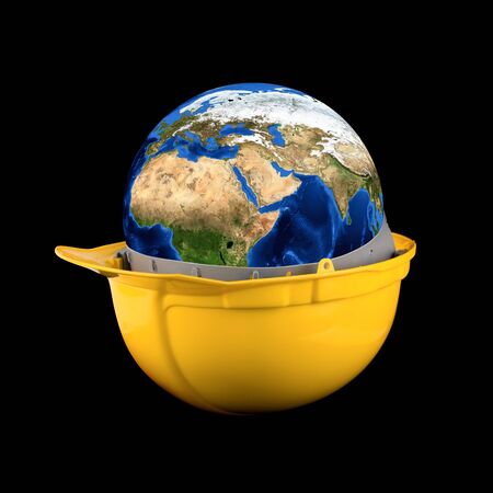 Yellow helmet with earth planet isolated on a black backgroundの写真素材