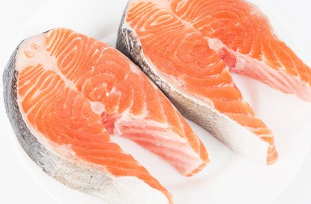 Red fish steak isolated on a white backgroundの写真素材