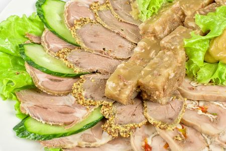 Closeup jellied minced meat and meat cuts on green saladの写真素材