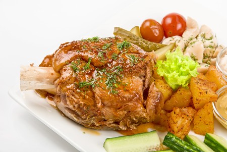 Tasty pork brisket dish with vegetables on a white backgroundの写真素材