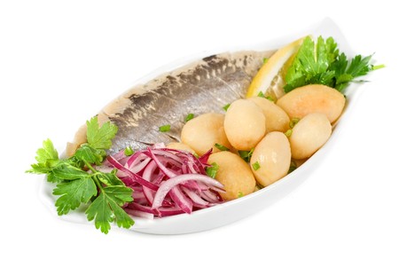 Herring with potato and vegetables isolated on a white backgroundの写真素材
