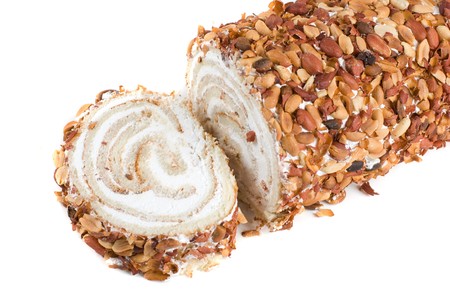 Nuts Swiss roll closeup isolated on a white backgroundの写真素材