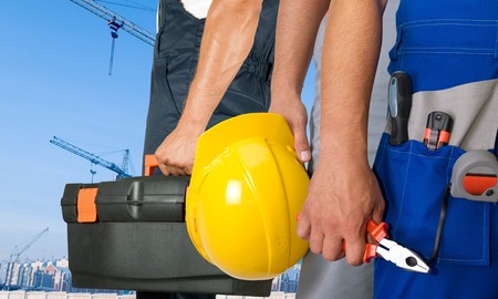 Different workers man closeup on building background
