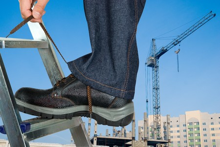 repairman lace his shoes on building backgroundの写真素材