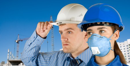 Portrait of young architects at in front of construction site, building and crane.の写真素材