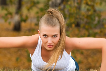 Beauty female doing push ups in the parkの写真素材
