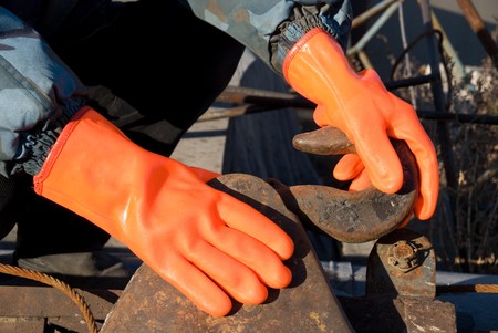 Closeup of worker man at orange glovesの写真素材