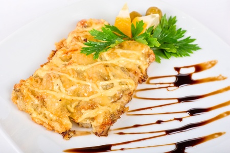 Roasted pork steak baked with cheese on whiteの写真素材