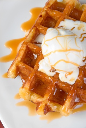 Tasty waffle and ice cream with creamの写真素材