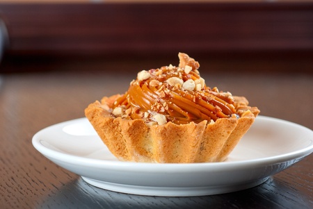 fresh baked cupcake with nuts on a wooden table