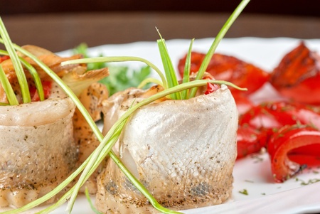 fillet of pikeperch stuffed with trout fish with baked pepper, tomato and leekの写真素材
