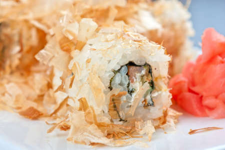 Sushi rolls of rice, nori, cream cheese, avocado, smoked salmon,cucumber and cuts of tunaの写真素材