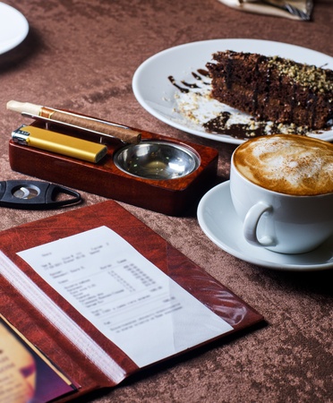 check, ashtray, cigar, lighter and coffee at restaurant tableの写真素材