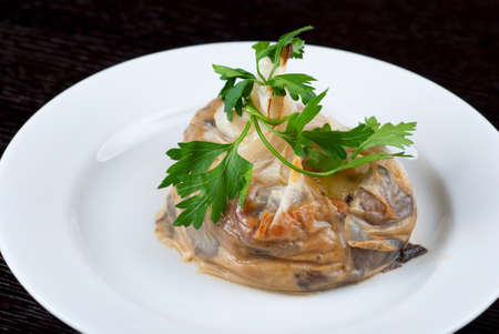 Tasty mushroom mix with cheese and cream wrapped at rice paper packetの写真素材