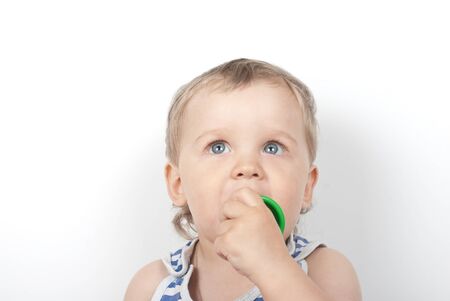 Small baby boy with a toy pyramid isolated on whiteの写真素材