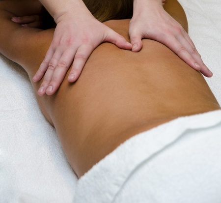 closeup of young woman getting a back massageの写真素材
