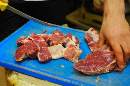 cutting a piece of fresh pork meatの写真素材