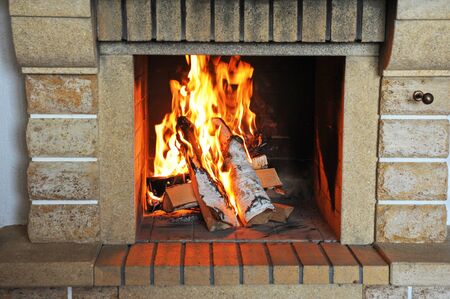 Fireplace with wood and fire closeupの写真素材