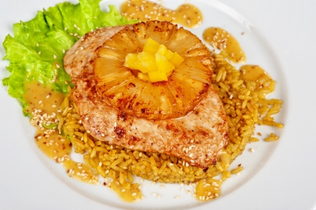 chicken fillet baked with pineapple, with rice and saladの写真素材